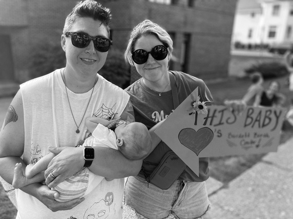 Emily Steinbach, right, her wife, Michele, and daughter Eleanor take part in a rally last month against the proposed closing of Burdett Birth Center, the only remaining medical facility in Rensselaer County where expectant mothers can give birth. Victoria Kereszi photo