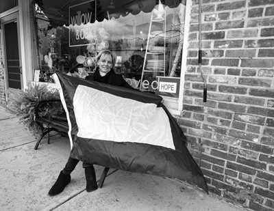 Cheryl Roberts of Spencertown shows off the purple-and-white flag she designed for Keep Hope Alive International, a new nonprofit group dedicated to promoting responsive government, religious liberty , tolerance, justice reform and other causes. Susan Sabino photo