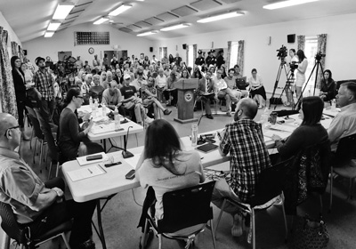 Representatives of state and national refugee resettlement organizations take questions from city aldermen and the public at a May 25 forum George Bouret photo
