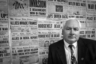 Matthew Rozell, a high school history teacher in Hudson Falls, stands in front of a classroom display of newspaper front pages from the World War II era. He will retire this month after 30 years of teaching, but he plans to continue collecting the accounts of World War II veterans and Holocaust survivors. Joan K. Lentini photo