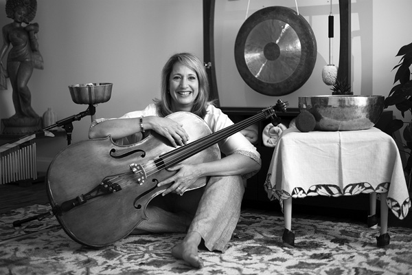 Demetria Konisis sits with her cello and other instruments she uses for sound therapy in her studio in Saratoga Springs. Joan K. Lentini photo