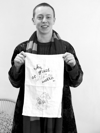 The Foundry’s Noah Bailey holds up one sample of the many fabric pieces, each quoting a presidential tweet, that form the “Tiny Pricks Project,” a new exhibit opening Dec. 7 at the venue.Susan Sabino photo