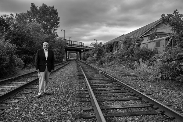 State Rep. John Barrett III, D-North Adams, stands along the tracks near the Western Gateway Heritage State Park. Barrett and others are pushing to restore passenger rail service from North Adams and Greenfield east to Boston, and a new state study details options for the project. Joan K. Lentini photo