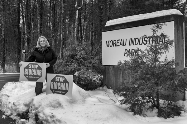 Gina LeClair holds signs opposing construction of the Saratoga Biochar Solutions facility that’s planned for a site at the Moreau Industrial Park in northern Saratoga County. Joan K. Lentini photo