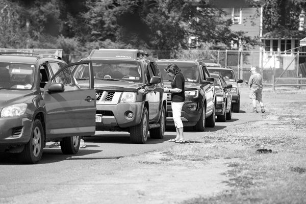 Cars line up to receive an emergency food packages May 26 at the Columbia County Fairgrounds. Regional food banks and local charitable organizations have organized a series of similar events around the region as unemployment has spiked upward amid the Covid-19 pandemic. Scott Langley photo