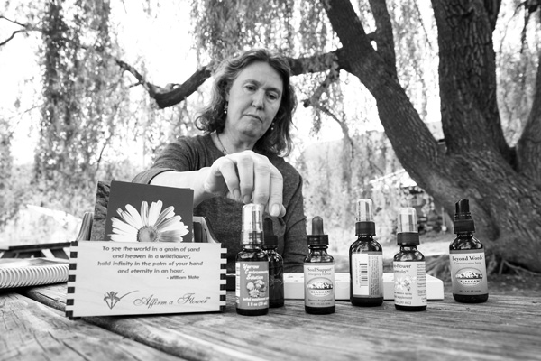 Moira Krum displays some of the dropper bottles of flower essences she uses in her therapy practice. Scott Langley photo